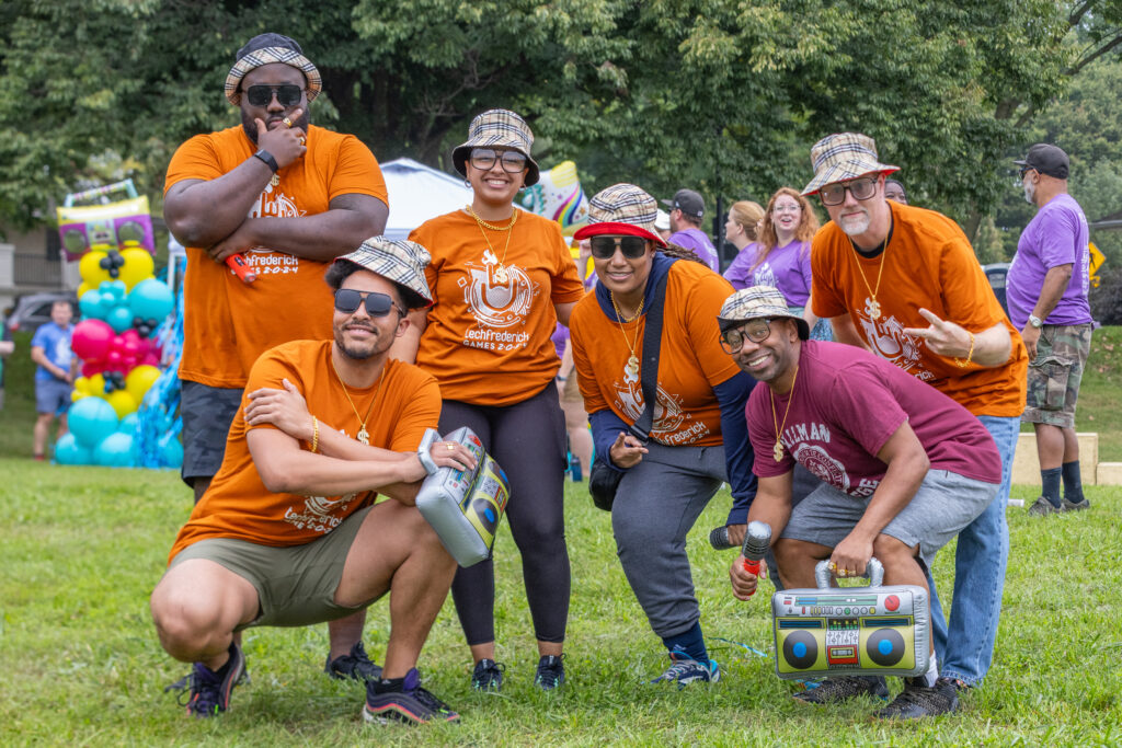 techfrederick Games team posing and wearing matching plaid bucket hats
