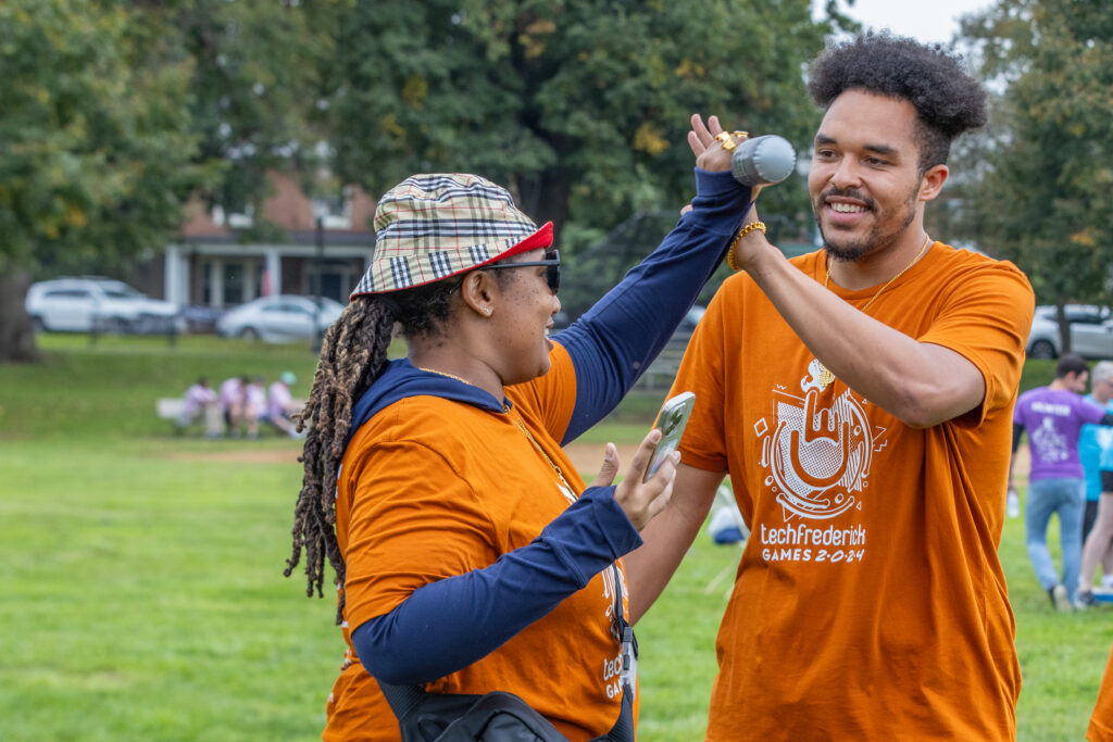 techfrederick Games participants on the same team high-fiving each other