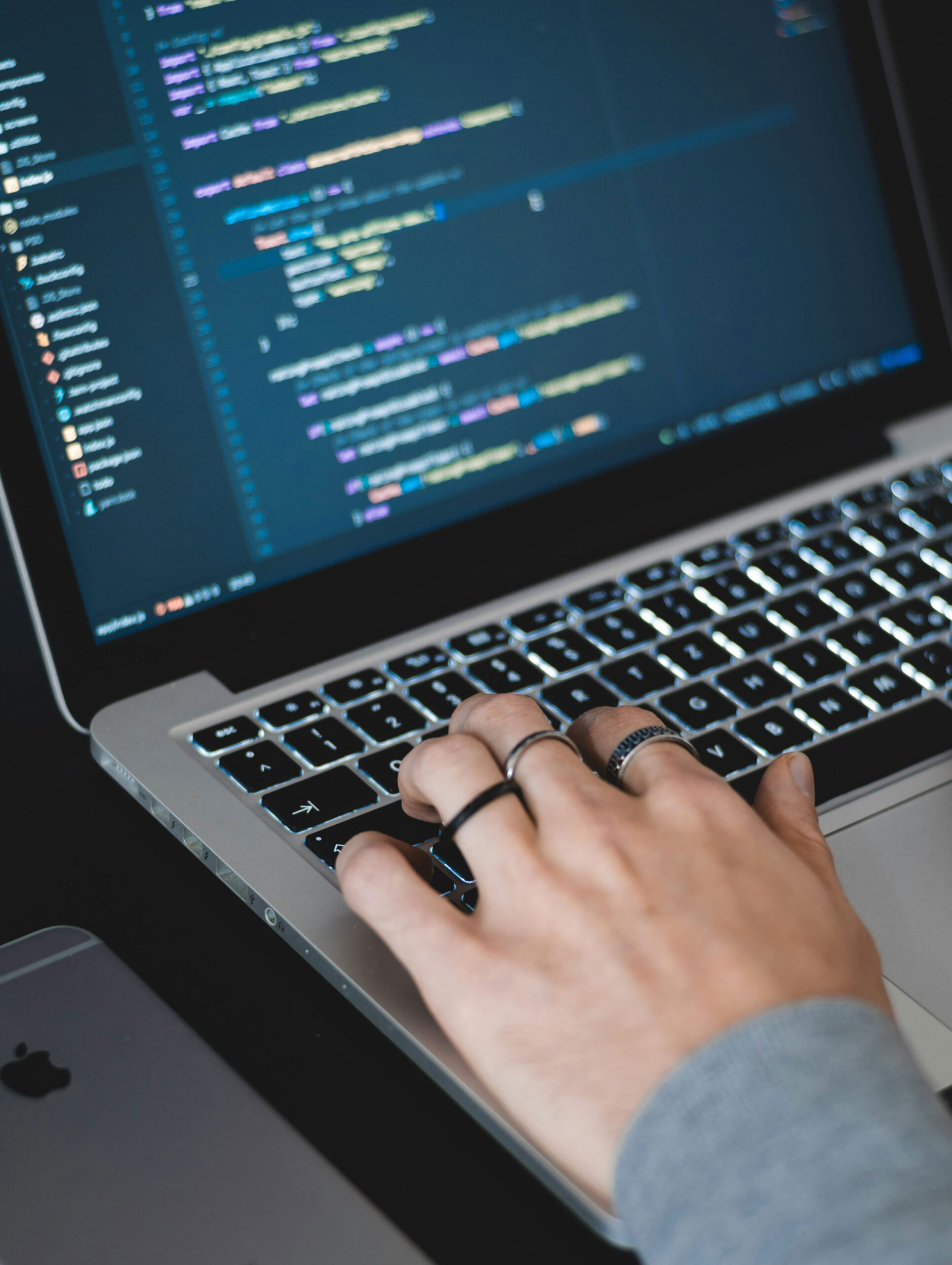 Hand typing on a laptop