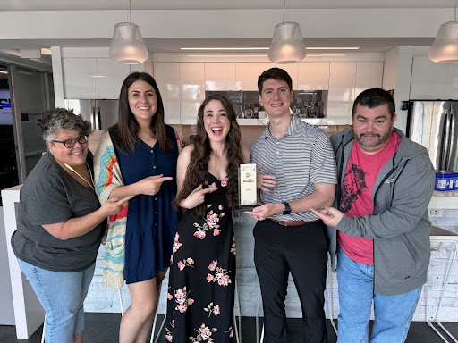 Orases employees smiling and holding an award for Inc.'s Annual List of Best workplaces